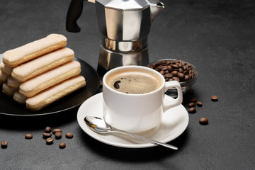 Italian Savoiardi ladyfingers Biscuits and cup of coffee on concrete backgound