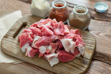 Fresh raw pork sliced on wooden background.