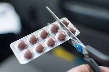 Blister with pills cut with scissors.