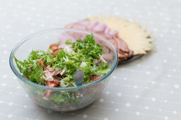 Cooking salad from fresh vegetables and cheese.