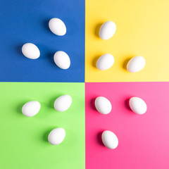 Set of white eggs on colorful four-color background. 