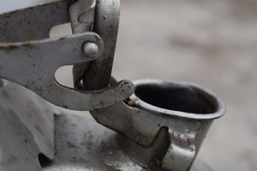 Open the top cover of an old metal barrel with an unknown substance inside