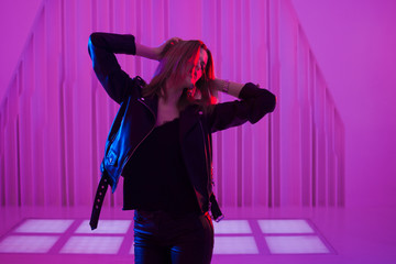 Beautiful girl dancing in retro wave on the neon light