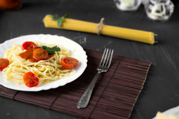 Spaghetti pasta in tomato sauce with cheese and parsley. Italian spaghetti pasta over dark stone...