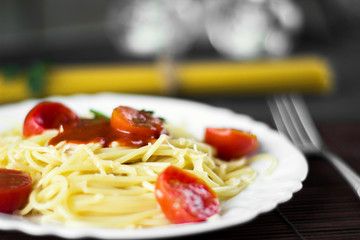 Spaghetti pasta in tomato sauce with cheese and parsley. Italian spaghetti pasta over dark stone background.