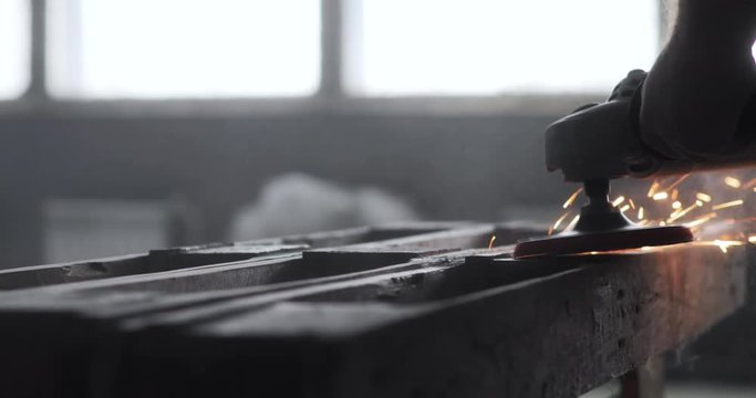 Carpenter polishing wood using electric grinder with polishing extender. close up