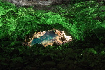 Jameos del Agua in Lanzarote, cave of volcanic origin illuminated with green light and a lake inside