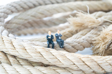 businessman walking on the long rope close up