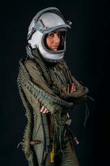 Young astronaut woman with helmet in studio © karrastock