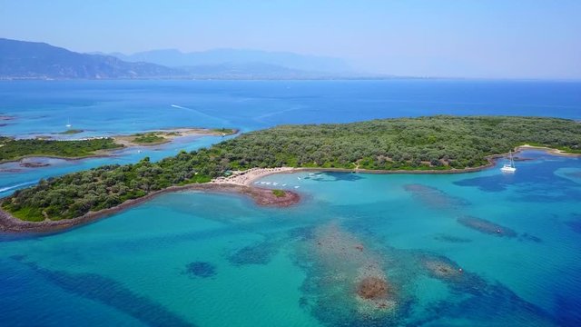 Aerial view video from famous organised beach in small island of Monolia part of archipelago paradise exotic islands of Lihadonisia with clear turquoise sea beaches, North Evoia island, Greece