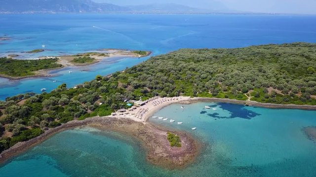 Aerial view video from famous organised beach in small island of Monolia part of archipelago paradise exotic islands of Lihadonisia with clear turquoise sea beaches, North Evoia island, Greece