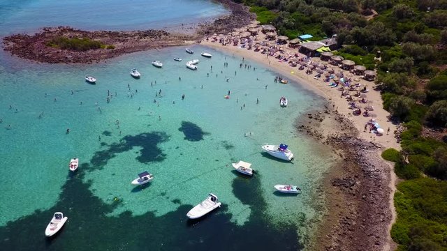 Aerial view video from famous organised beach in small island of Monolia part of archipelago paradise exotic islands of Lihadonisia with clear turquoise sea beaches, North Evoia island, Greece