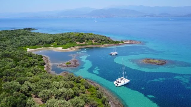 Aerial view video from famous organised beach in small island of Monolia part of archipelago paradise exotic islands of Lihadonisia with clear turquoise sea beaches, North Evoia island, Greece