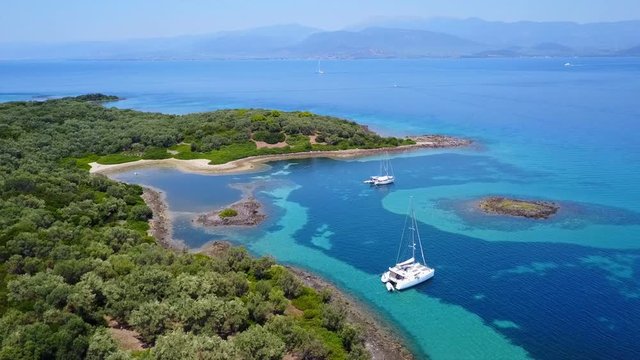 Aerial view video from famous organised beach in small island of Monolia part of archipelago paradise exotic islands of Lihadonisia with clear turquoise sea beaches, North Evoia island, Greece