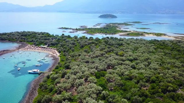 Aerial view video from famous organised beach in small island of Monolia part of archipelago paradise exotic islands of Lihadonisia with clear turquoise sea beaches, North Evoia island, Greece