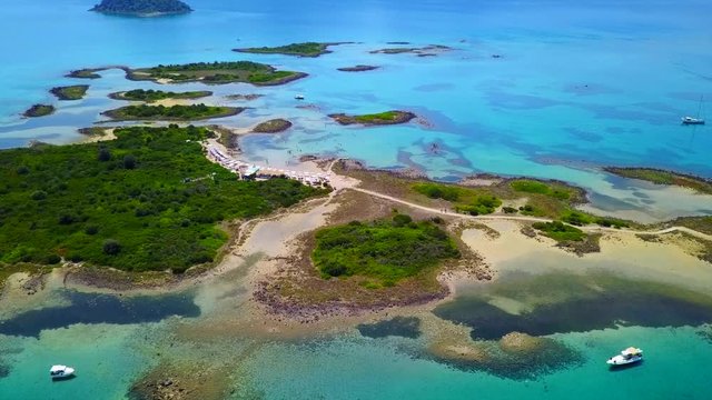 Aerial view video from famous organised beach in small island of Monolia part of archipelago paradise exotic islands of Lihadonisia with clear turquoise sea beaches, North Evoia island, Greece