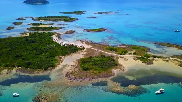 Aerial view video from famous organised beach in small island of Monolia part of archipelago paradise exotic islands of Lihadonisia with clear turquoise sea beaches, North Evoia island, Greece
