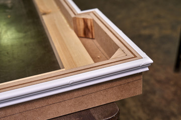 Crown molding. Home library with classic design. Wooden furniture manufacturing process