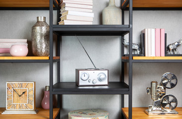 Compact radio on bookshelf in vintage living room interior