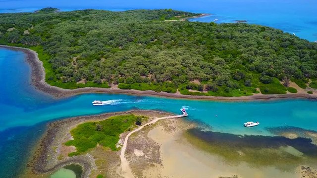 Aerial view video from famous organised beach in small island of Monolia part of archipelago paradise exotic islands of Lihadonisia with clear turquoise sea beaches, North Evoia island, Greece