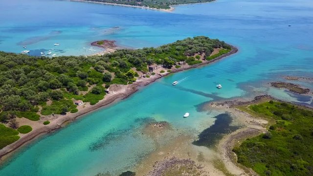 Aerial view video from famous organised beach in small island of Monolia part of archipelago paradise exotic islands of Lihadonisia with clear turquoise sea beaches, North Evoia island, Greece