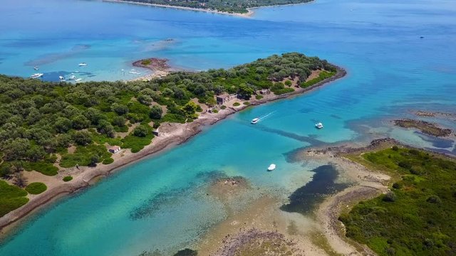 Aerial view video from famous organised beach in small island of Monolia part of archipelago paradise exotic islands of Lihadonisia with clear turquoise sea beaches, North Evoia island, Greece