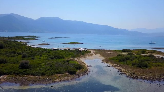 Aerial view video from famous organised beach in small island of Monolia part of archipelago paradise exotic islands of Lihadonisia with clear turquoise sea beaches, North Evoia island, Greece