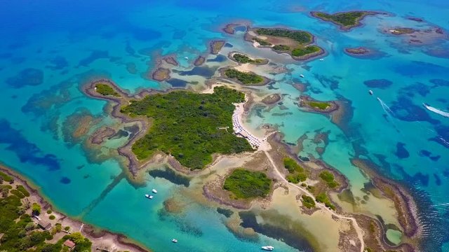 Aerial view video from famous organised beach in small island of Monolia part of archipelago paradise exotic islands of Lihadonisia with clear turquoise sea beaches, North Evoia island, Greece