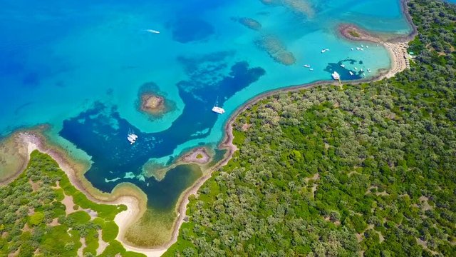 Aerial view video from famous organised beach in small island of Monolia part of archipelago paradise exotic islands of Lihadonisia with clear turquoise sea beaches, North Evoia island, Greece