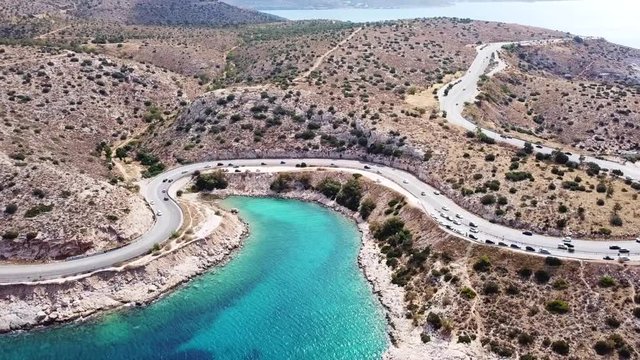 Aerial drone bird's eye view video of Tunel in Athens riviera seaside road known as hole of Karamanlis, Attica, Greece