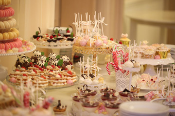Delicious candy bar with macarons, cupcakes, cake pop and other sweets