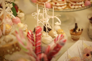 Delicious candy bar with macarons, cupcakes, cake pop and other sweets