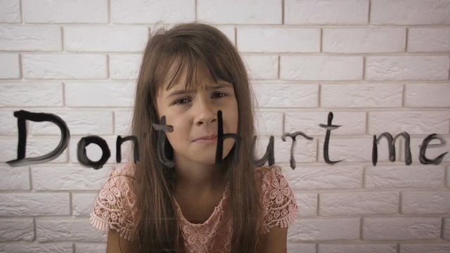 Dont hurt me. Child abuse. The frightened little girl asks not to offend her.
