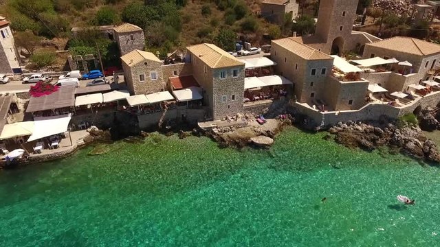 Aerial birds eye view video taken by drone of famous picturesque village of Limeni with turquoise clear waters, Peloponnese, Greece