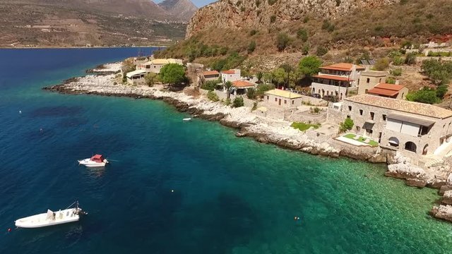 Aerial birds eye view video taken by drone of famous picturesque village of Limeni with turquoise clear waters, Peloponnese, Greece