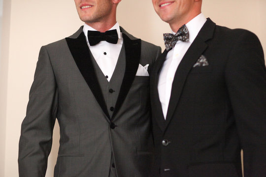 Men posing in tuxedo
