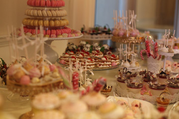 Delicious candy bar with macarons, cupcakes, cake pop and other sweets