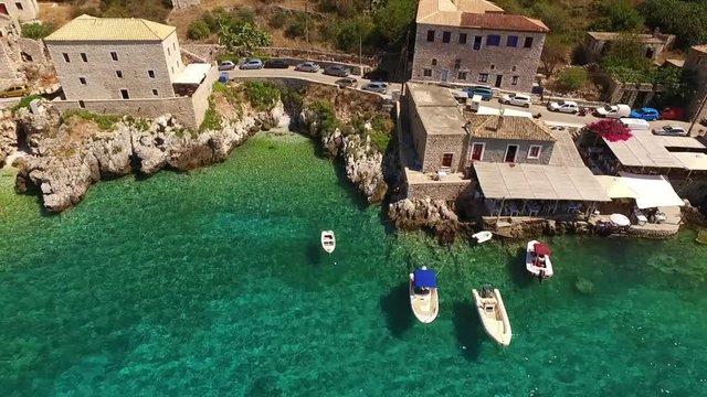 Aerial birds eye view video taken by drone of famous picturesque village of Limeni with turquoise clear waters, Peloponnese, Greece