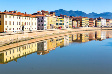 Fototapeta na wymiar Buildings in Pisa reflected in the Arno River