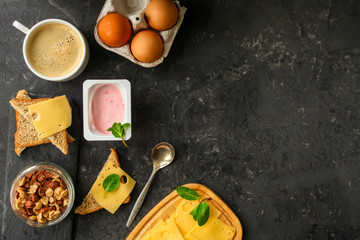 Fototapeta na wymiar breakfast or snack (coffee, yogurt, cheese, sandwiches, cornflakes and more). Food background.