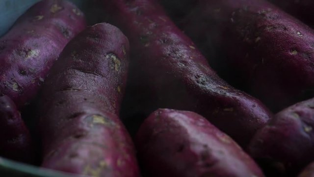 Sweet potatoes are hot steamed cooked footage slow motion