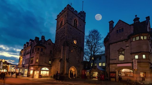 Time lapse view of Carfax tower in the center of Oxford at sunset with full moon