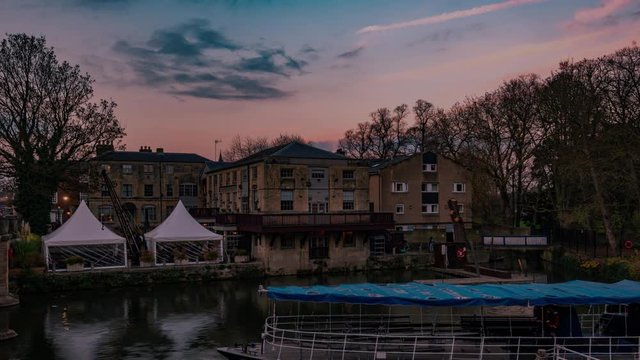 Time lapse view of a riverside pub in Oxford at sunset with full moon