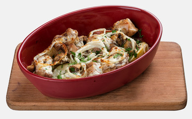 Rabbit baked in sour cream with onion in ceramic bowl