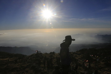 silhouette of man on top of mountain