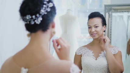 Beautifu bride choosing wedding dress in a wedding salon