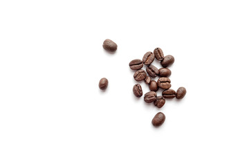Roasted coffee beans isolated on white background. Close-up.