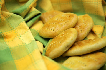 Fresh baked fragrant wheat bread beautifully spread out on the background.