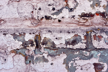 Cracked paint, plaster of soft gray-pink pastel color on brick wall surface close up detail, grunge horizontal shabby background