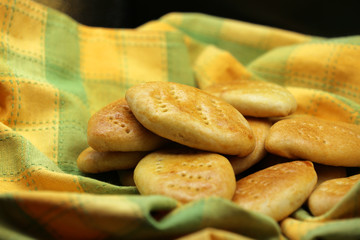 Fresh baked fragrant wheat bread beautifully spread out on the background.